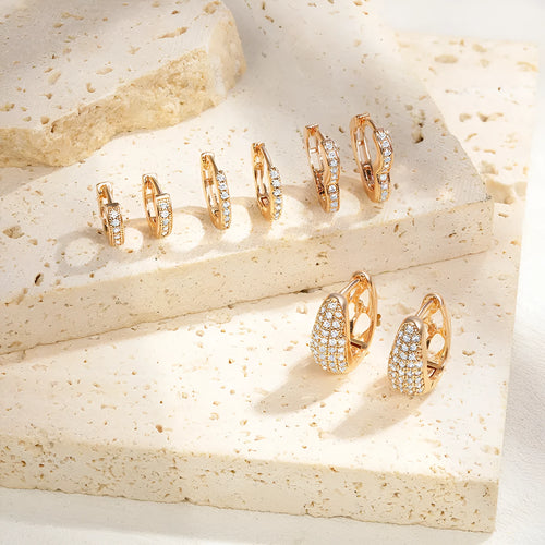 Gold plated heart shaped ear clip earrings with cubic zirconia stones on copper base