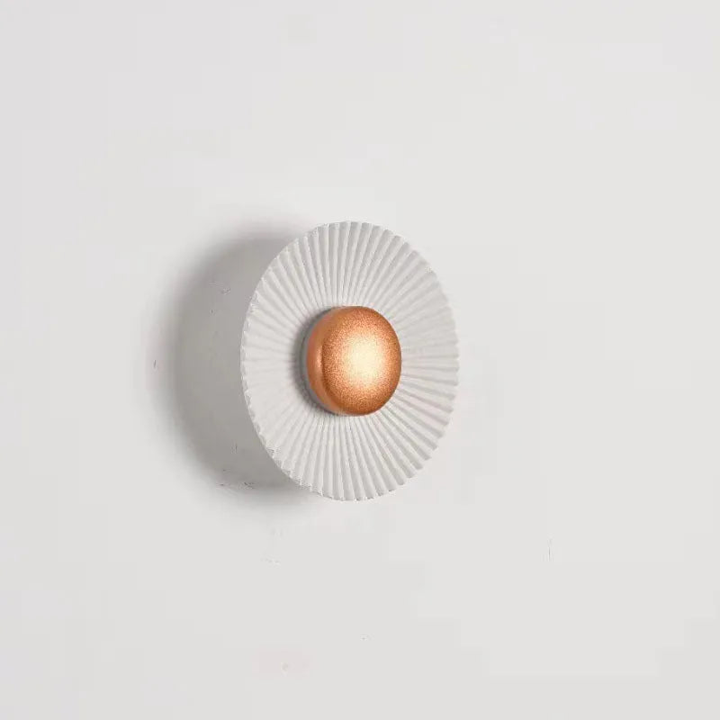 Round aluminium LED wall lamp in a dual-colour finish mounted on a wall.