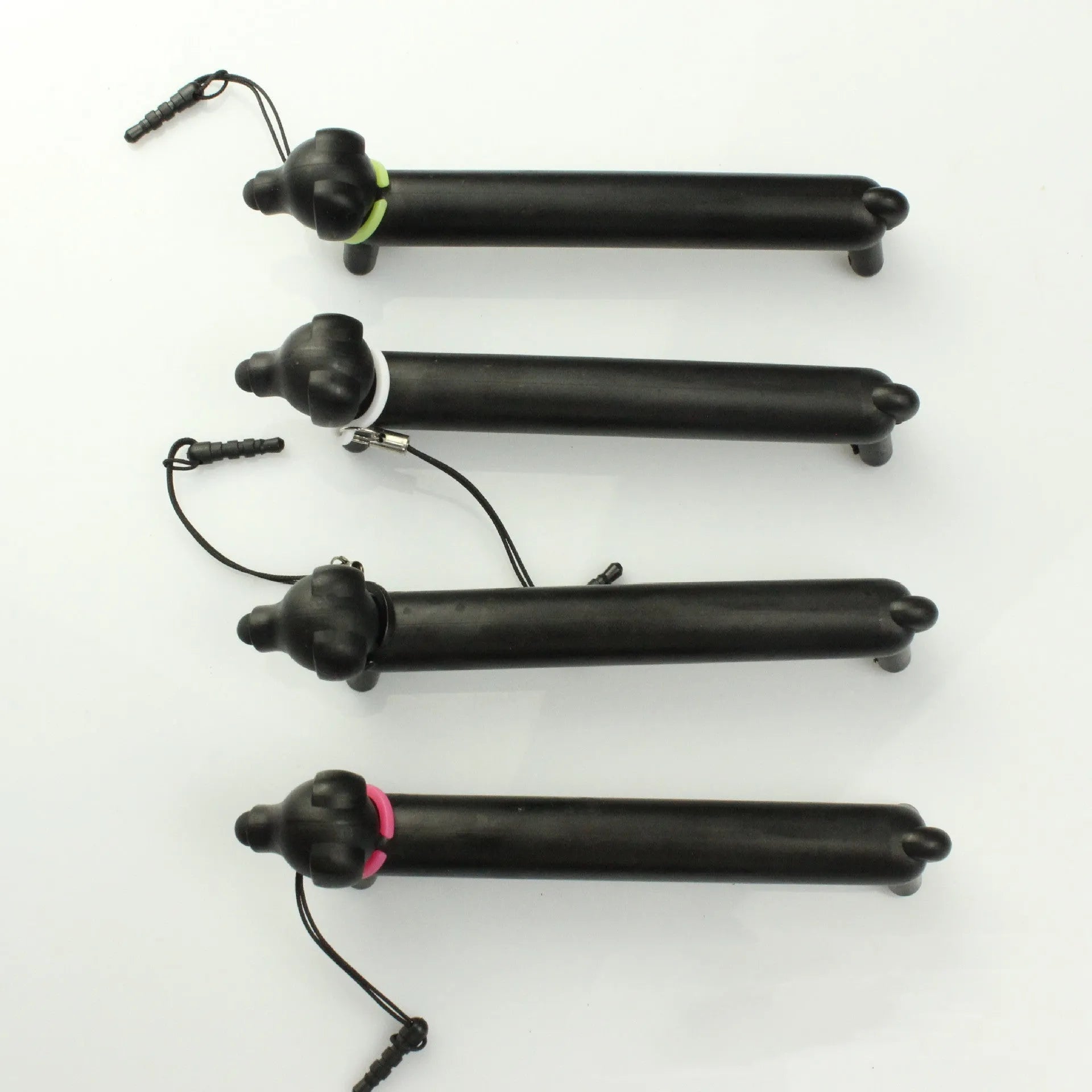 Black dog-shaped touch screen stylus showing length adjustment and phone holder function
