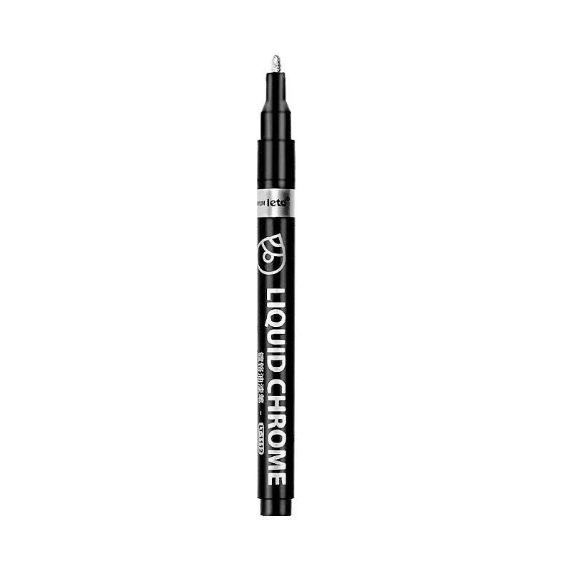 Metal mirror chrome plated marker pen with reflective metallic tip on a smooth surface