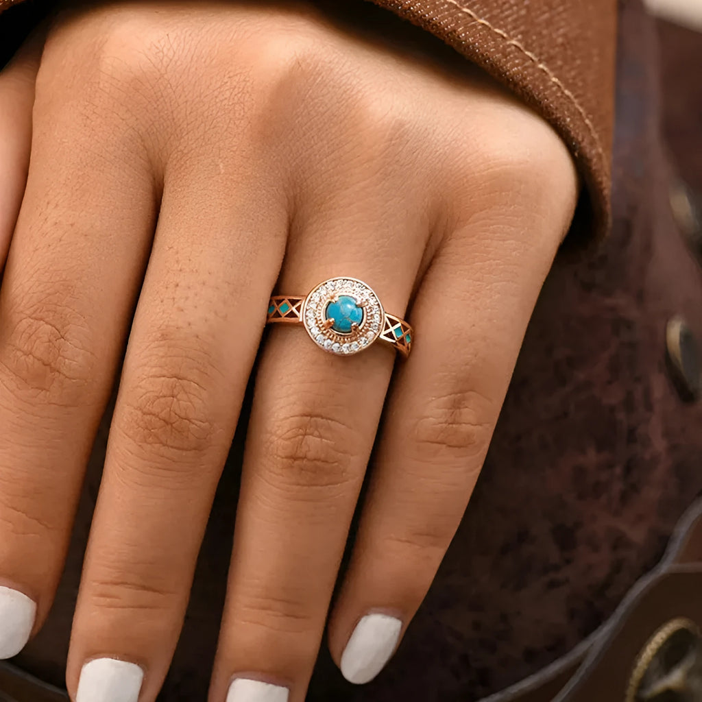 Women's rose gold copper ring with geometric design and inlaid turquoise-style zircon stones.