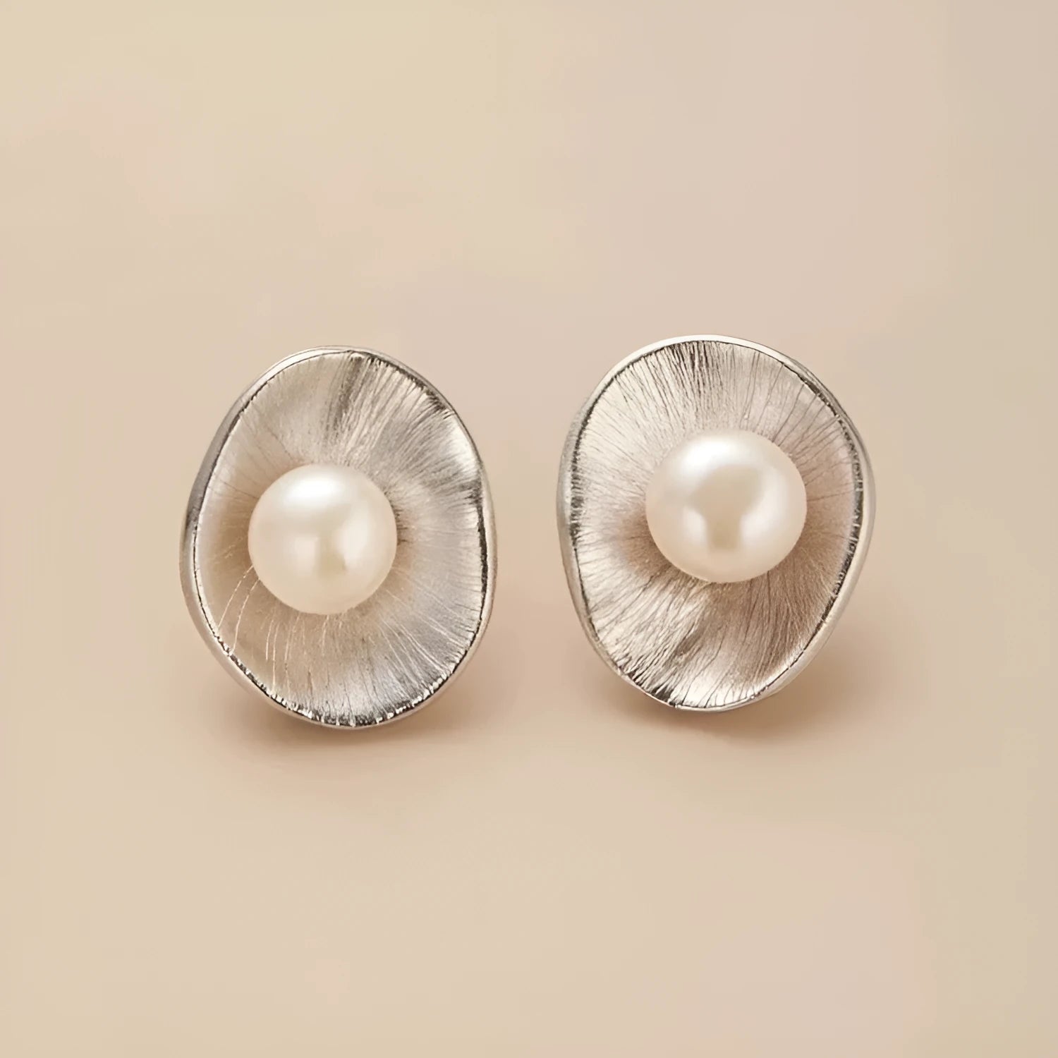 Sterling silver earrings with geometric design and cultured pearl accents on needle back fittings