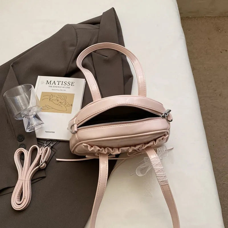 Ladies shoulder handbag with bandage bow design in PU leather showing phone pocket compartment