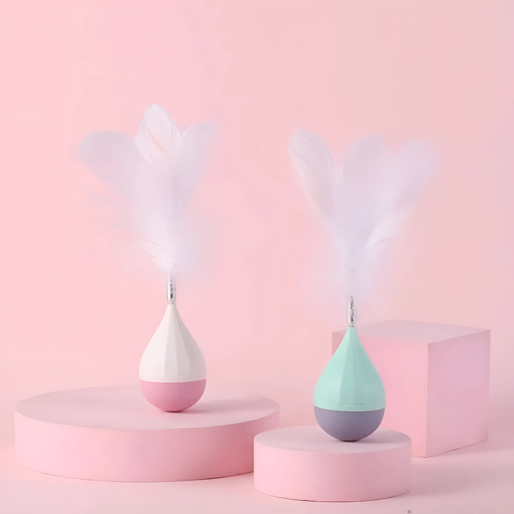 Feather Tumbler Cat Toy with goose feathers and aluminium alloy construction on pink background