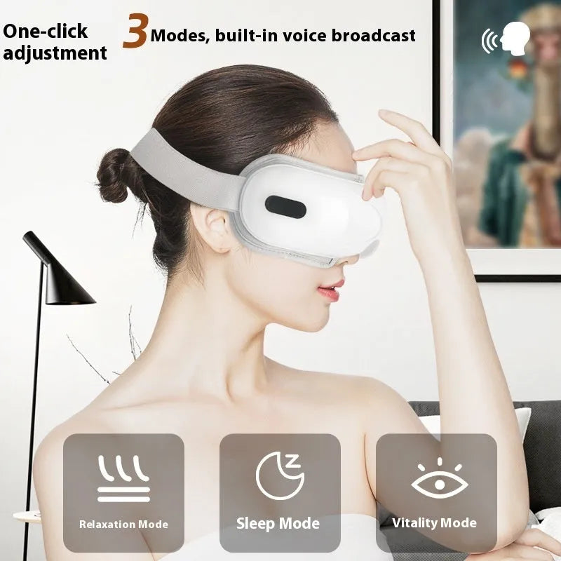 White rechargeable eye massager with hot compress and airbag massage functions on a grey background