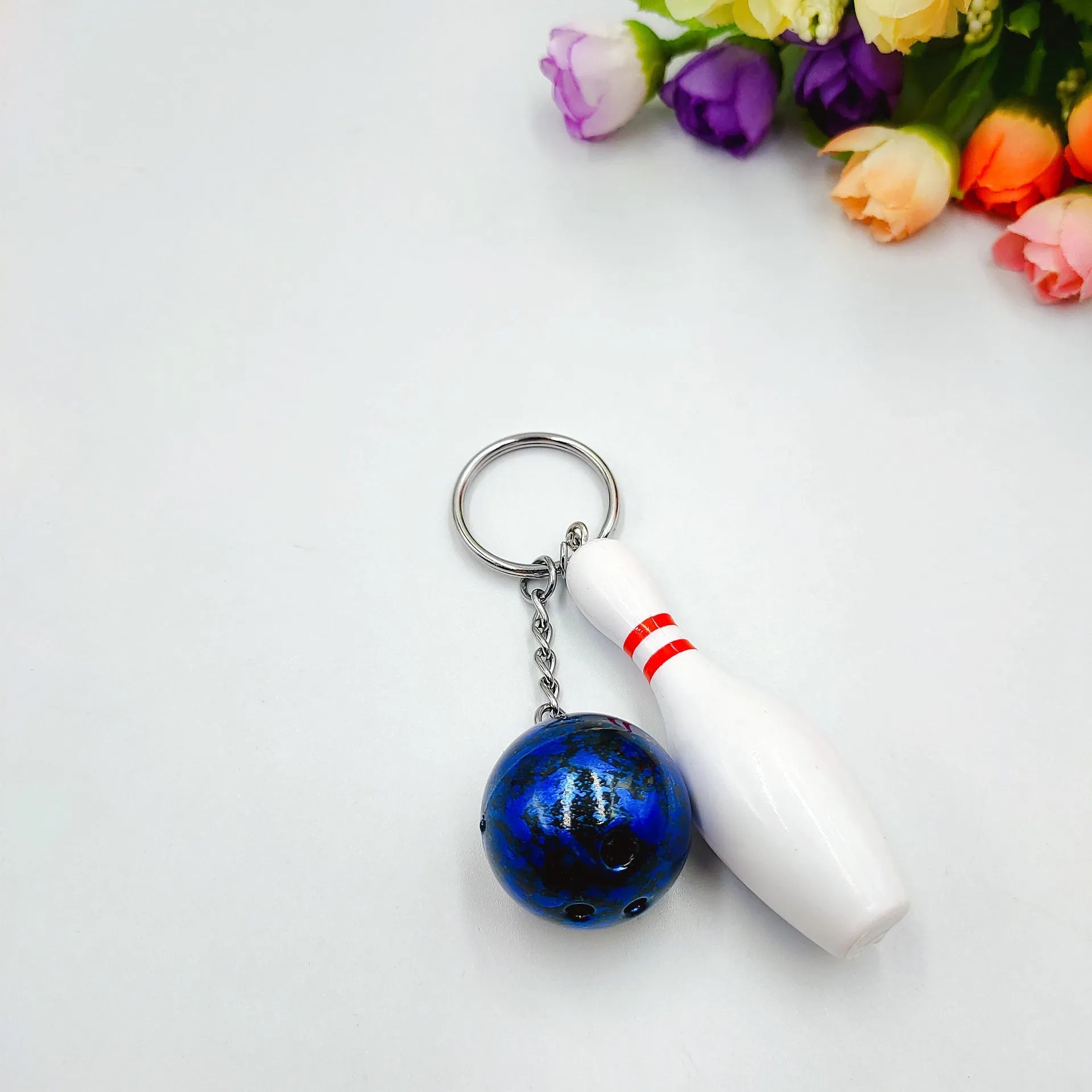 Mini bowling pin keychain pendant in four colour options with key ring attachment
