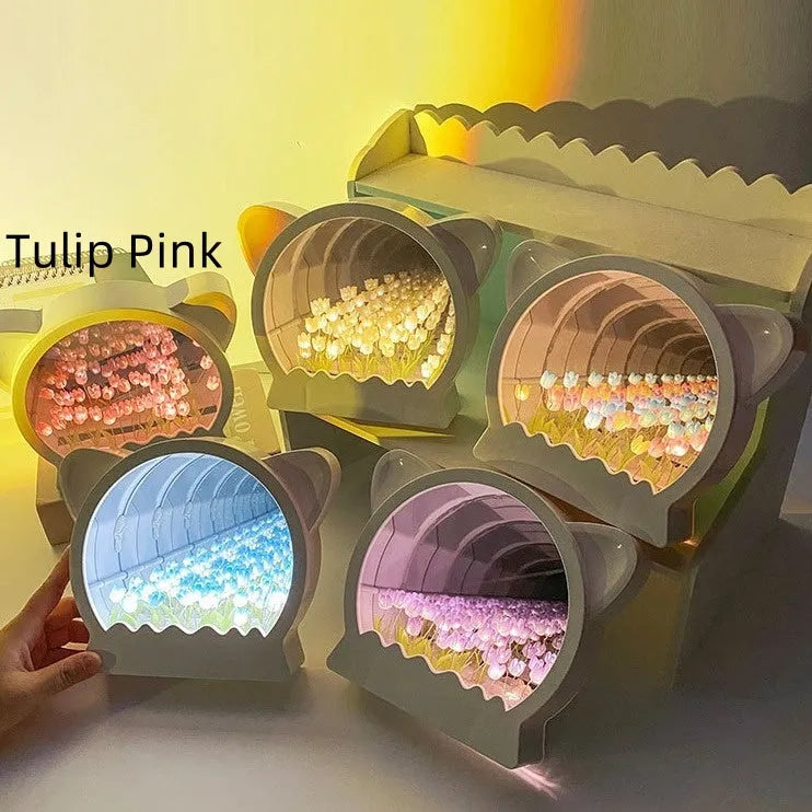 Handmade DIY cat head shaped night lamp surrounded by colourful tulip flowers on a table.