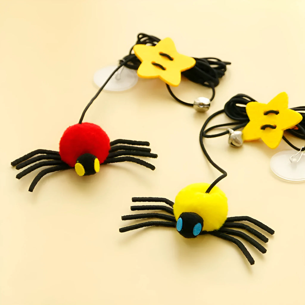 Hanging door cat toy with elastic rope, feather, bell, and spider attachment in red colour