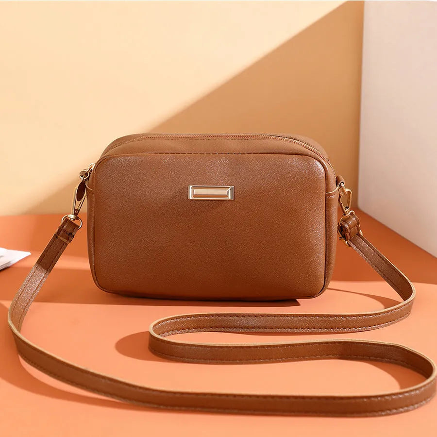 Solid colour women's PU shoulder bag with three-dimensional pocket design in urban simple style